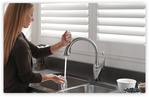 Woman using faucet